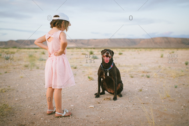 Young girl looking at a panting dog