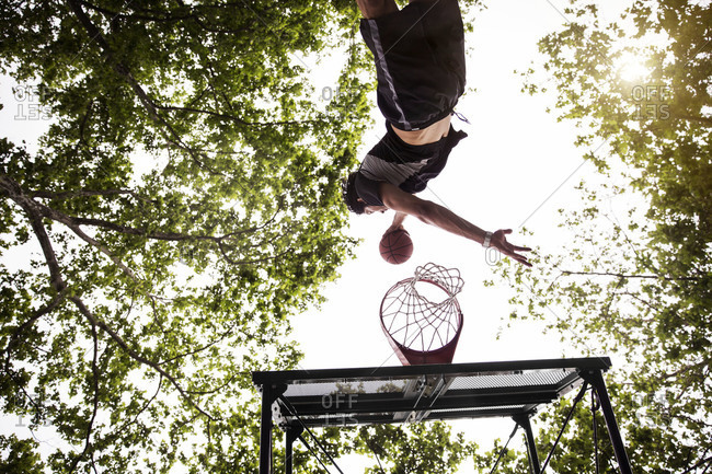 Man slam dunking a basketball into the hoop