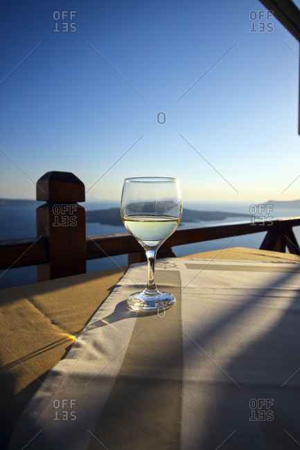 Wine glass standing on a table at evening twilight