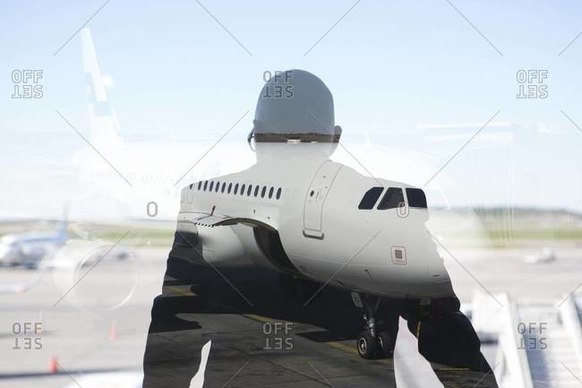 Silhouette of a person looking at a jet