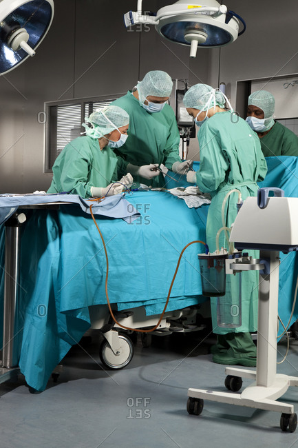 Doctors and nurses operating on a patient in a operating room