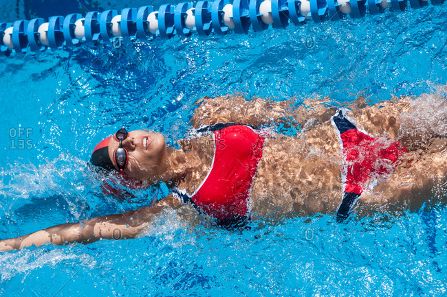 Woman with red bikini swimming in pool