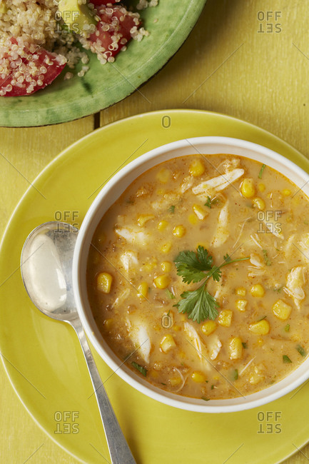 Close up of chicken and sweet corn soup with quinoa salad