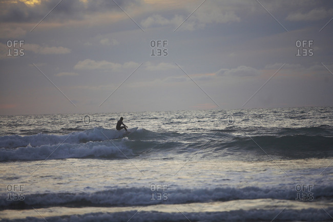 Person surfing in the evening