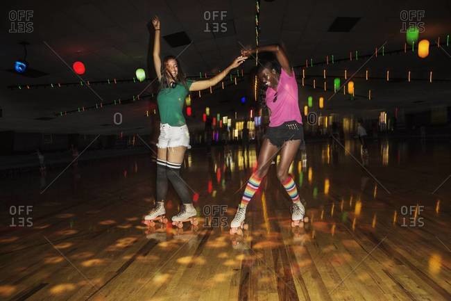Young women dancing at a roller skate rink