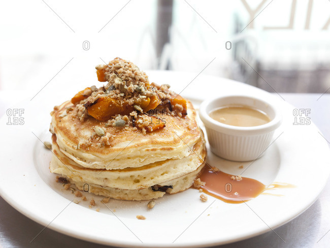 Pumpkin pancakes with pumpkin seed streusel topping and salted caramel sauce