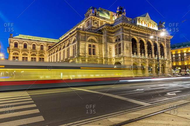 View to State Opera House at twilight with driving tramway in the foreground, Vienna, Austria