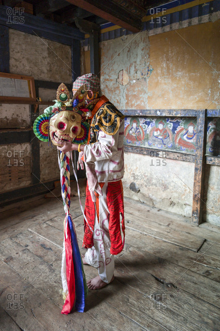 Dancer holding a mask at a Religious festival in Bhutan