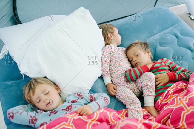 Children sleeping on inflatable mattress