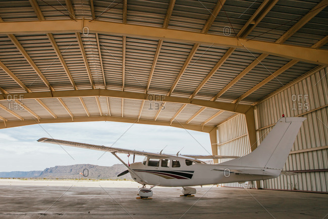 An airplane parking in a hangar