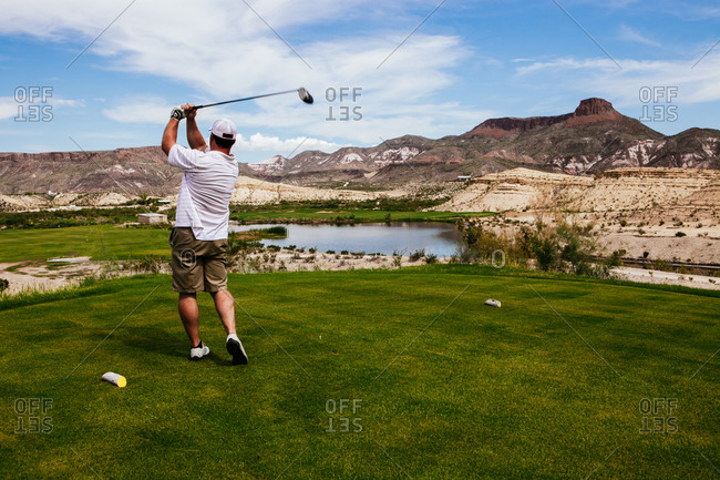 A golfer tees off at a golf resort, Lajitas, Texas