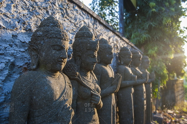 Late afternoon light on stone statues in the Pura Besakih temple complex, Bali, Indonesia