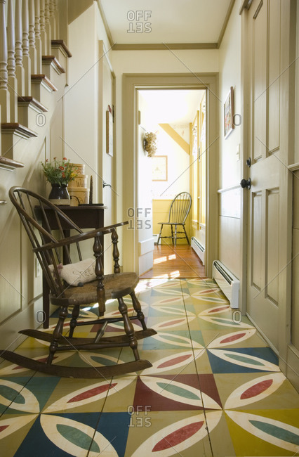 Hallway in colonial home with patterned wooden floor
