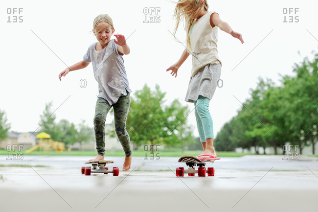 Girls riding skateboards on the street