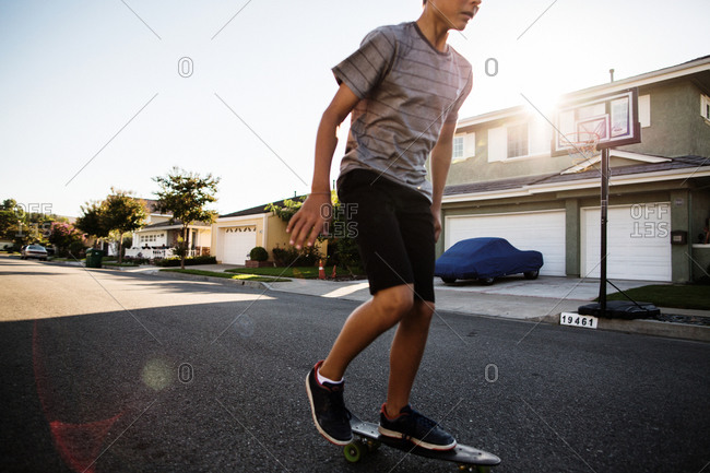 Young boy skateboarding on a street