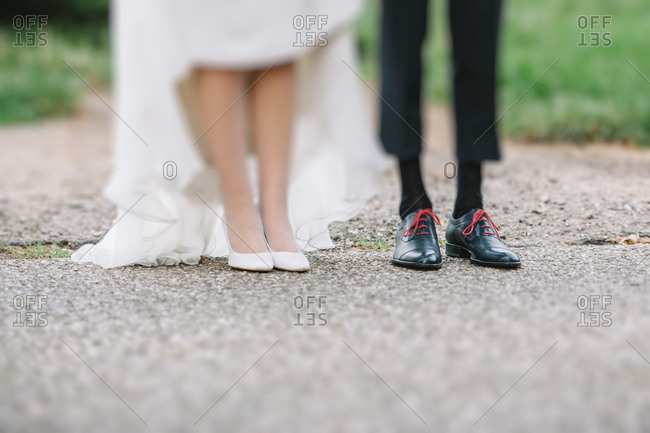 Close up of the feet of a newlywed couple