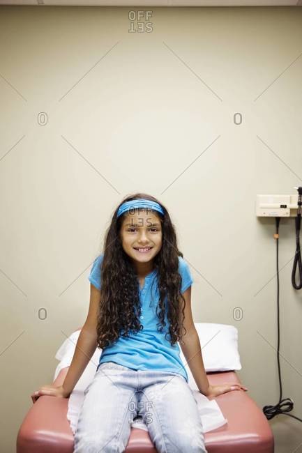 Little girl sitting at the doctor\'s office