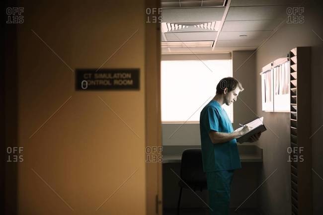 Doctor taking notes of x-rays