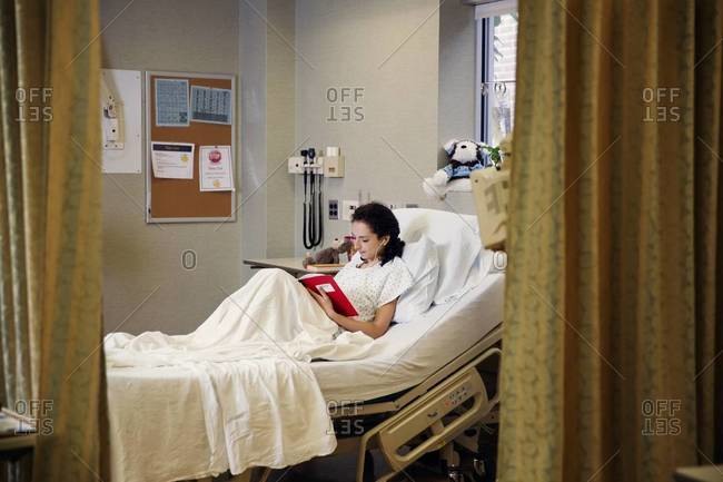 Young woman lying in a hospital bed