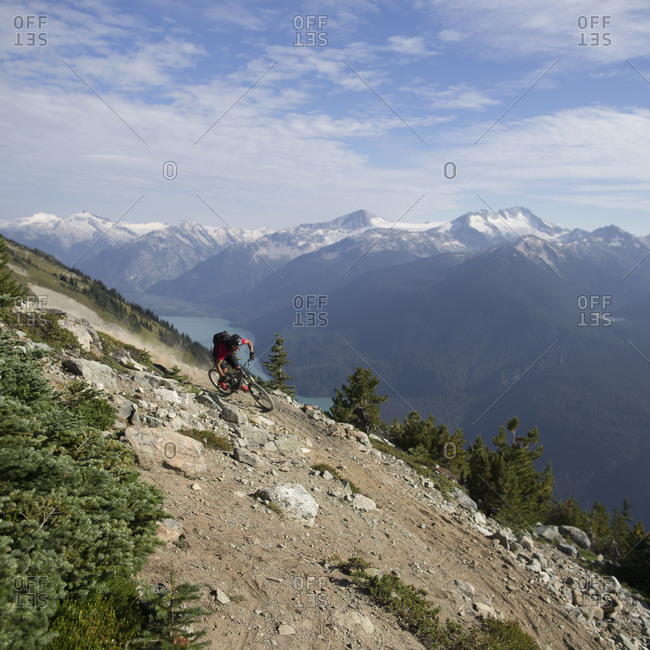 Mountain biker rides down a trail in the Whistler Mountain