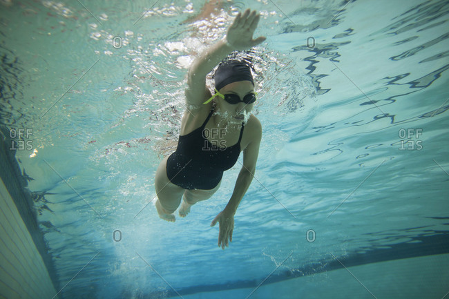 Woman practicing freestyle swimming in a pool