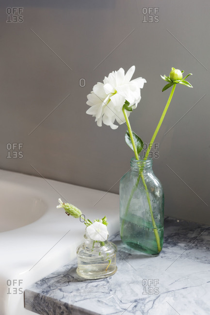 Floral arrangements sit on a counter