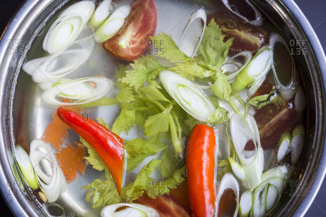 Vegetables cook in a hot pot in a restaurant in Danang, Vietnam