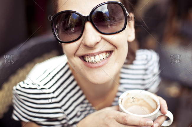 Woman drinking coffee and smiling