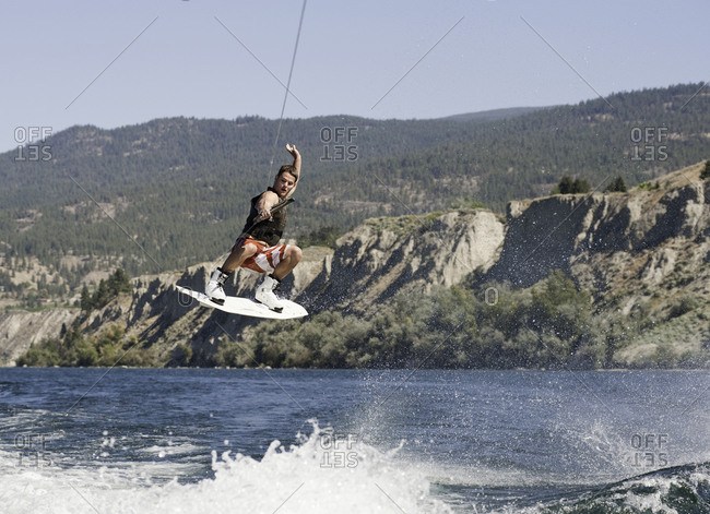 Man performing a wakeboarding stunt on a lake in Penticton, Canada
