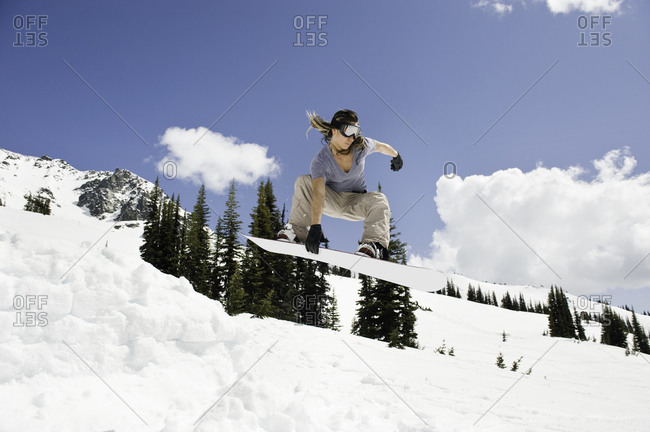 Woman snowboarding on a mountainside