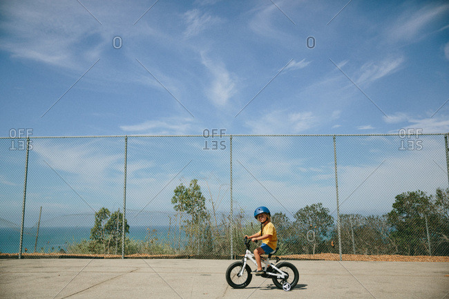 Young boy riding a bicycle on a street