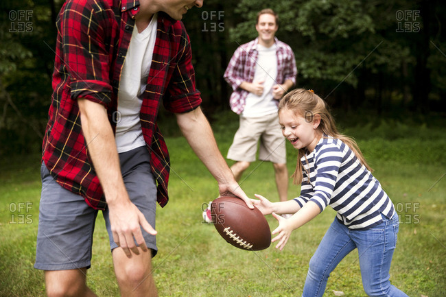 Man playing American football with a girl