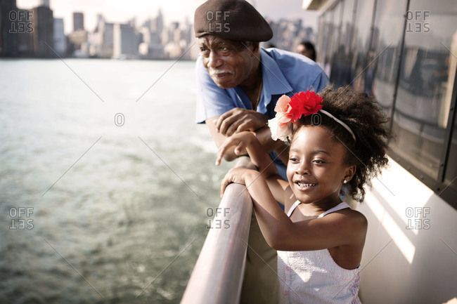 Grandfather and granddaughter on the East River ferry, New York