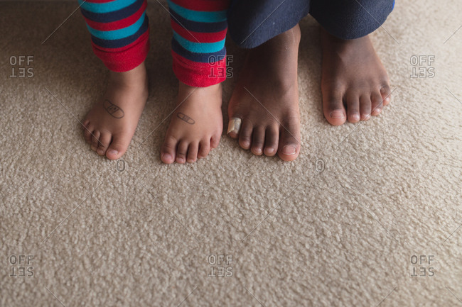 Close up of children\'s feet with bandage and bandages drawn on