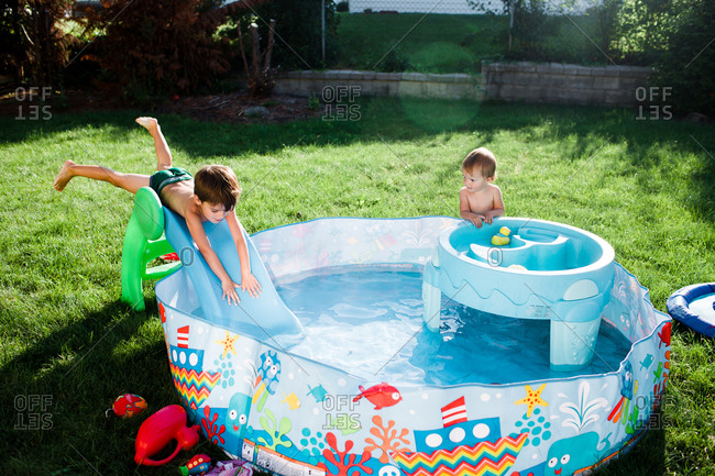 Two children play in a kiddie pool