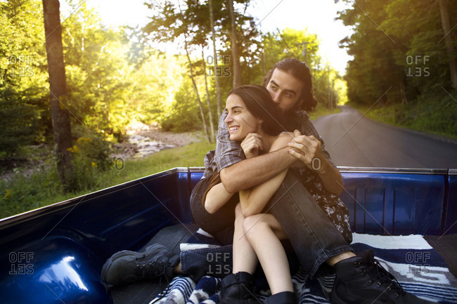 Couple cuddling in truck bed