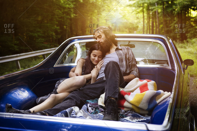 Couple lying down in truck bed