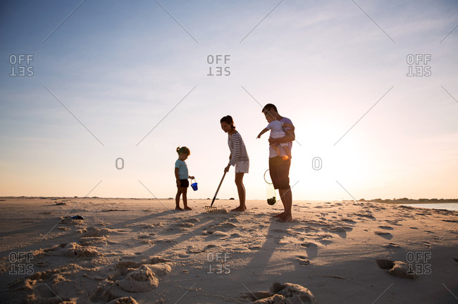 Family searching for clams on the beach