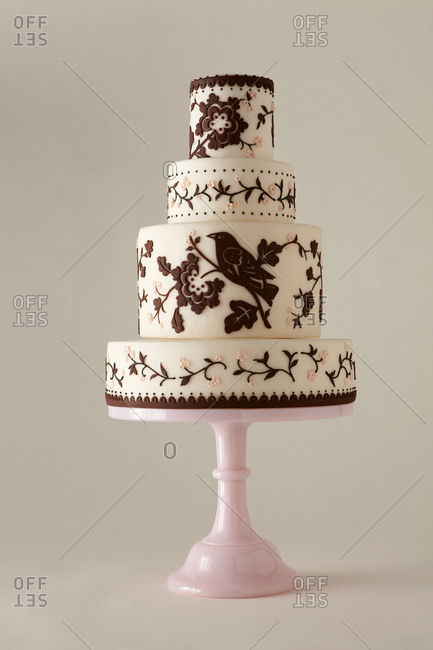 Four-tiered cake decorated with flowers and birds