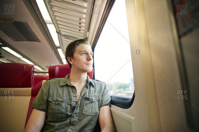 Man staring out of a train window