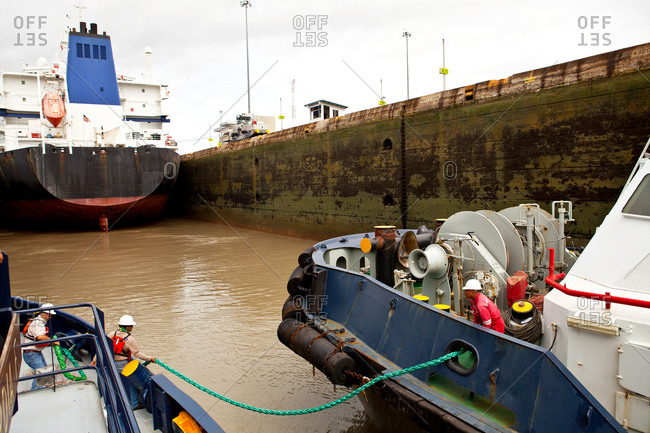 Crews of tugboats passing through Panama Canal