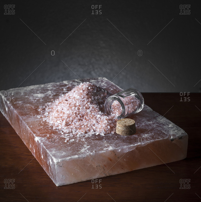 Pile of pink Himalayan salt on a salt block