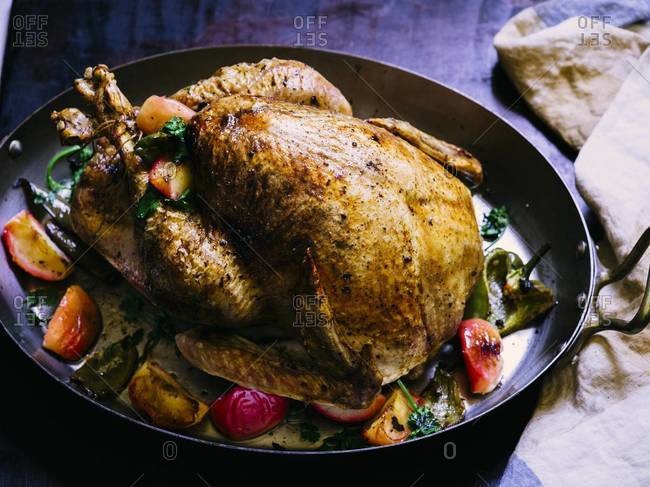 Whole roasted turkey served with apples and peppers