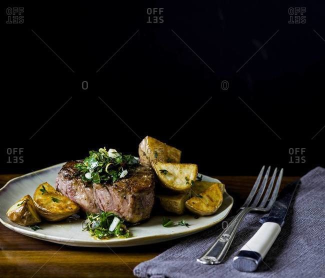Seared beef tenderloin with gremolata topping served with roasted potatoes