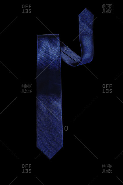 Dark blue necktie against black background
