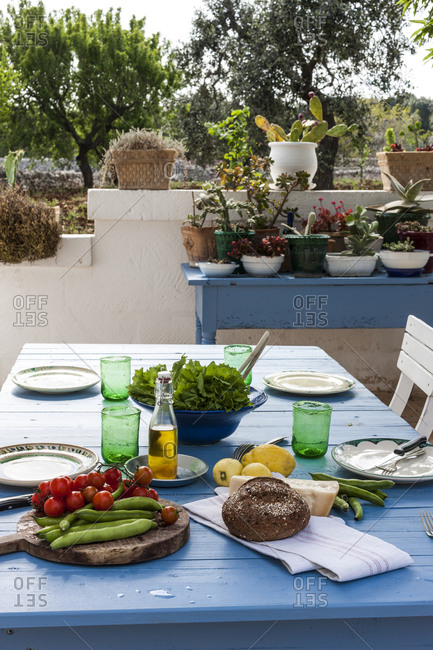 Table on terrace with picnic food in Puglia, Italy