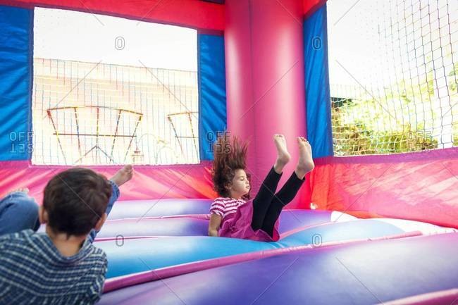 Girl falling in bouncy castle
