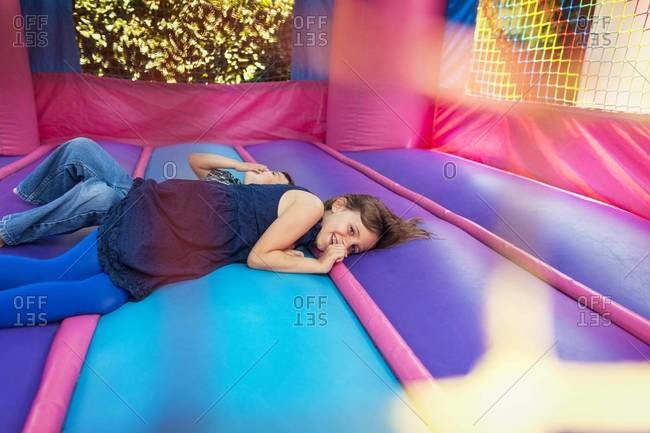 Two children laying down in bounce house