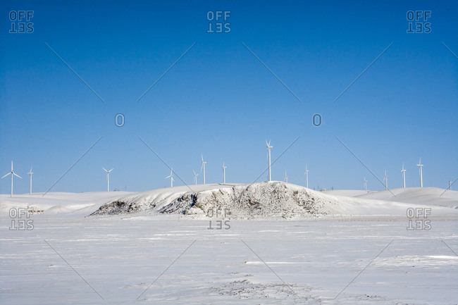View of a wind farm in a snowy field