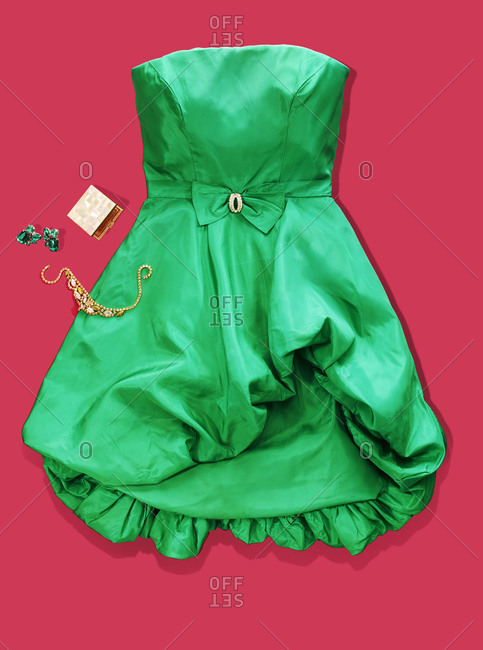Green cocktail dress on red background